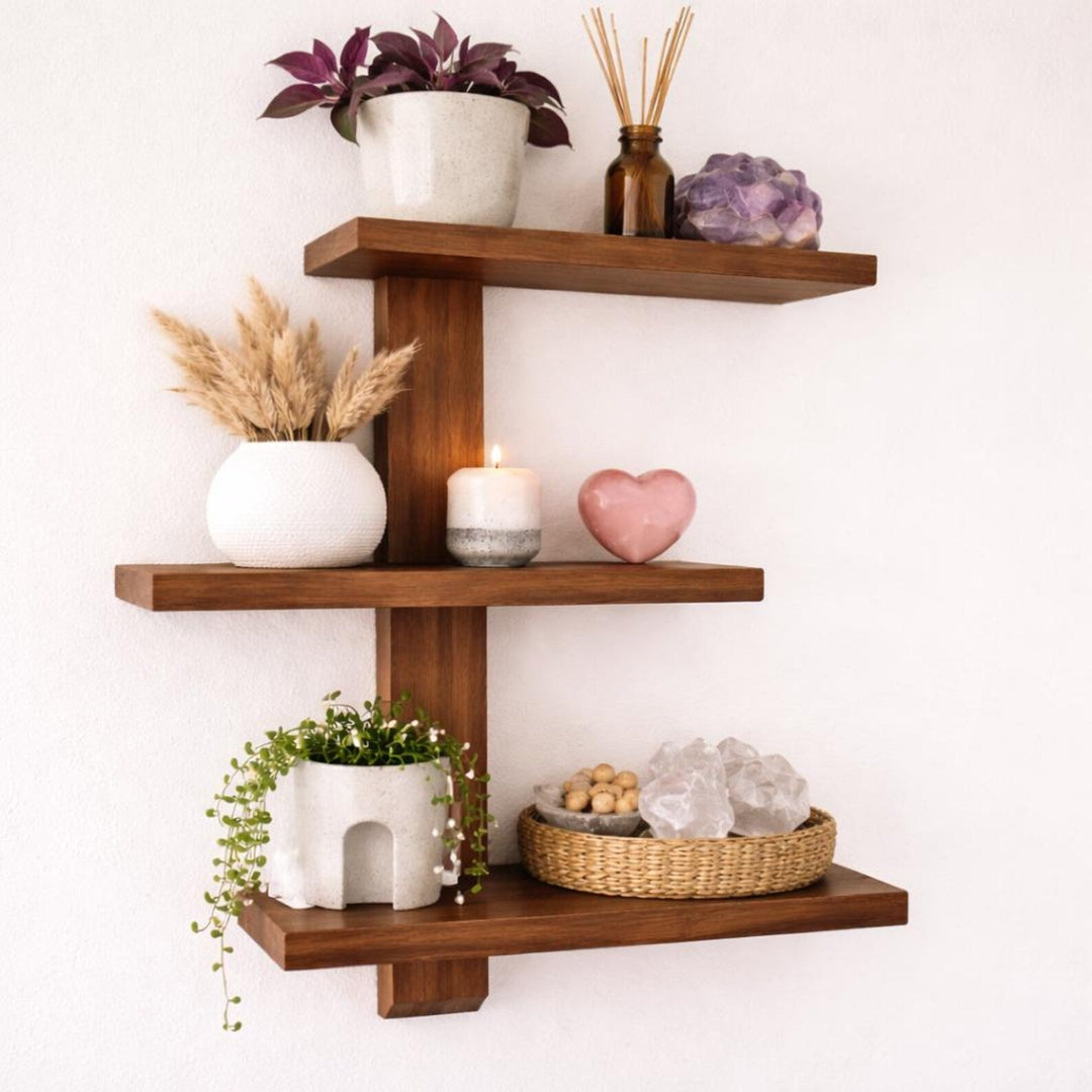 Floating wood trinket shelves showcasing plants, candles, and decorative items for organized storage.