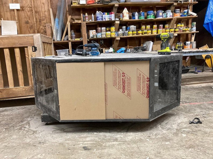 black PVC reptile enclosure under construction with tools in a workshop setting.