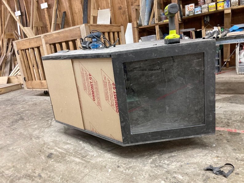 Black PVC reptile enclosure under construction, designed for humidity control and reptile display.