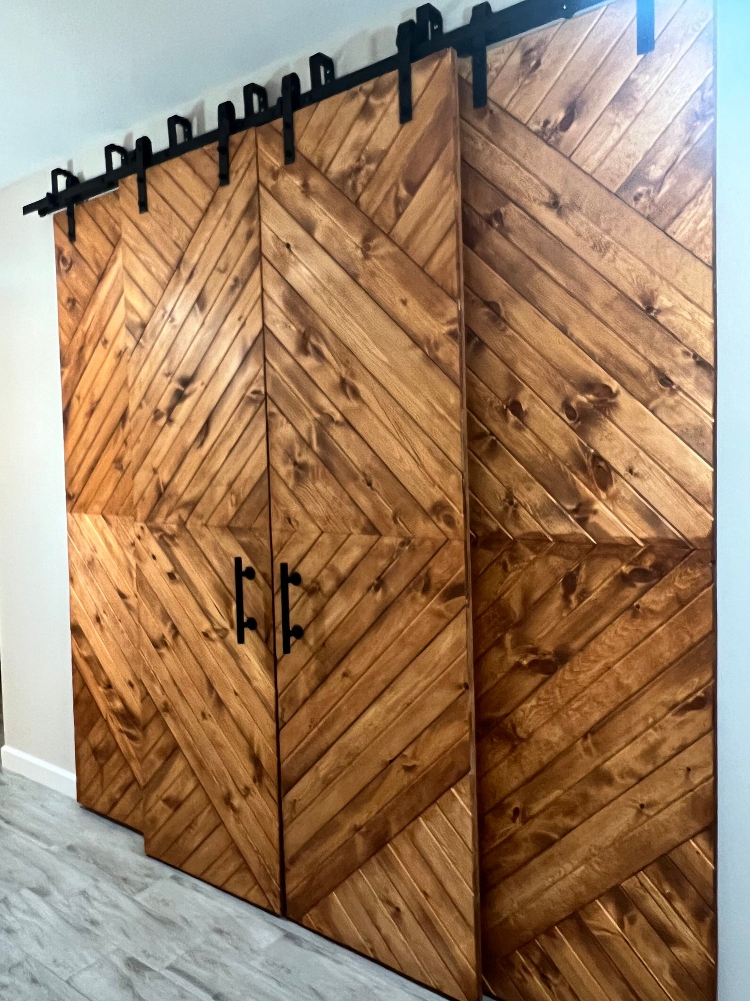 Custom Chevron Barn Door made of solid pine with a modern rustic style and bold chevron pattern.