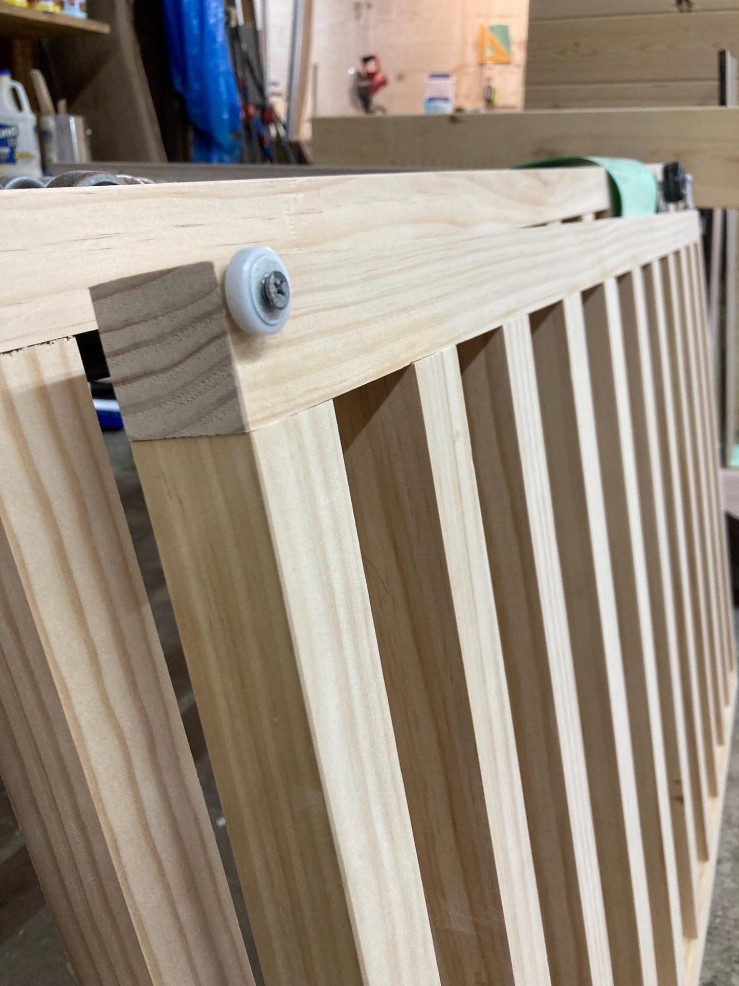 modern sliding slat baby gate close-up showing wooden slats and concealed sliding track craftsmanship