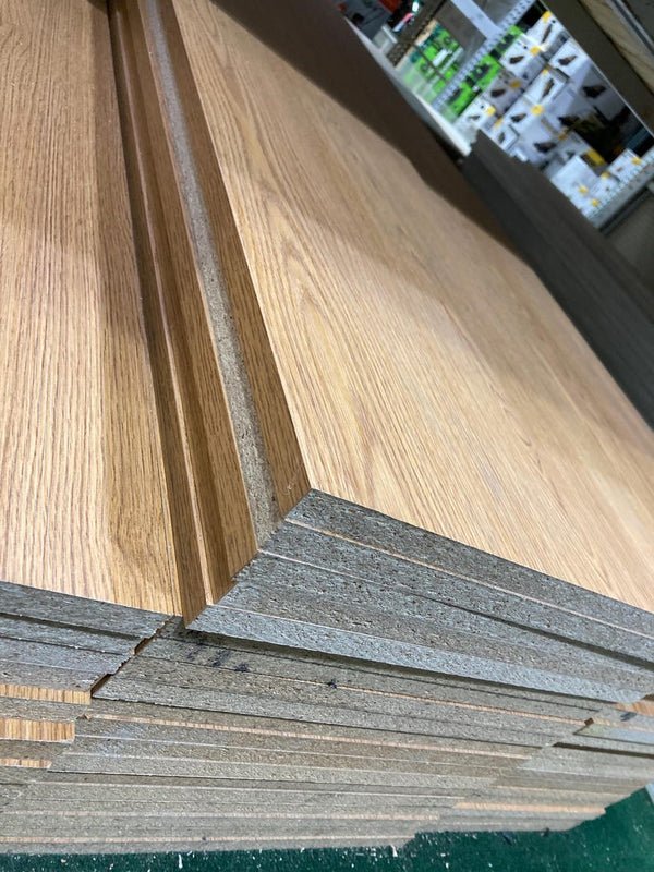 Stack of charcoal melamine shelves showcasing a natural wood finish and precision cut edges.