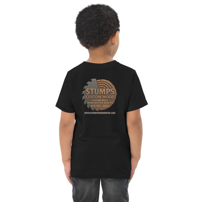 Stumps Custom Wood Toddler jersey t-shirt displayed on a child wearing a black shirt showcasing the brand logo on the back.