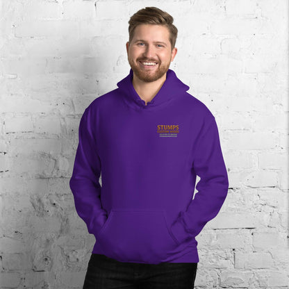 Man wearing Stumps Custom Wood Unisex Hoodie in purple against a white brick wall, designed for comfort and style.